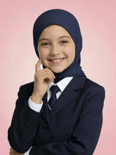 Young girl wearing a navy hijab and dark blazer on a pink background