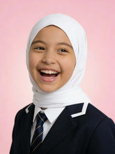 Child wearing a white hijab and dark suit with a pink background