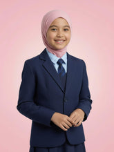 Child wearing a navy blue school uniform with a pink hijab on a pink background