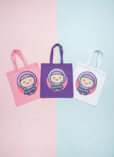 Three tote bags in pink, purple, and white with a cartoon character and 'Bunni Girl' text on a pastel background. Bubble Girl hijab