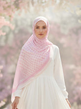 Woman wearing a pink hijab and white dress in a cherry blossom garden bubble girl