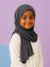 Girl wearing the charcoal jersey hijab for girls, three quarter front view