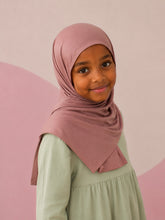 Girl wearing the dusty rose jersey hijab for girls, three quarter front view