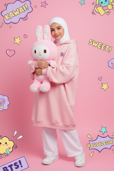 girl wearing a pink hoodie dress and holding a plush toy against a pink background with cartoon elements.