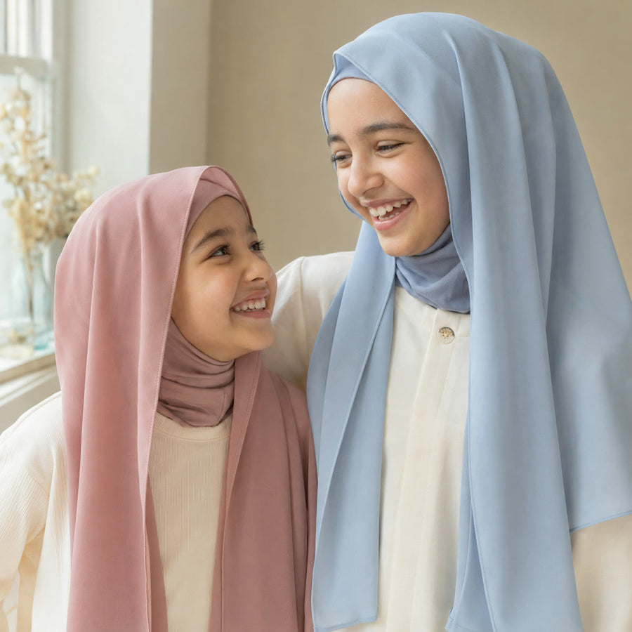 Two FeatherLite instant hijabs for girls in dusty pink and light blue, worn together