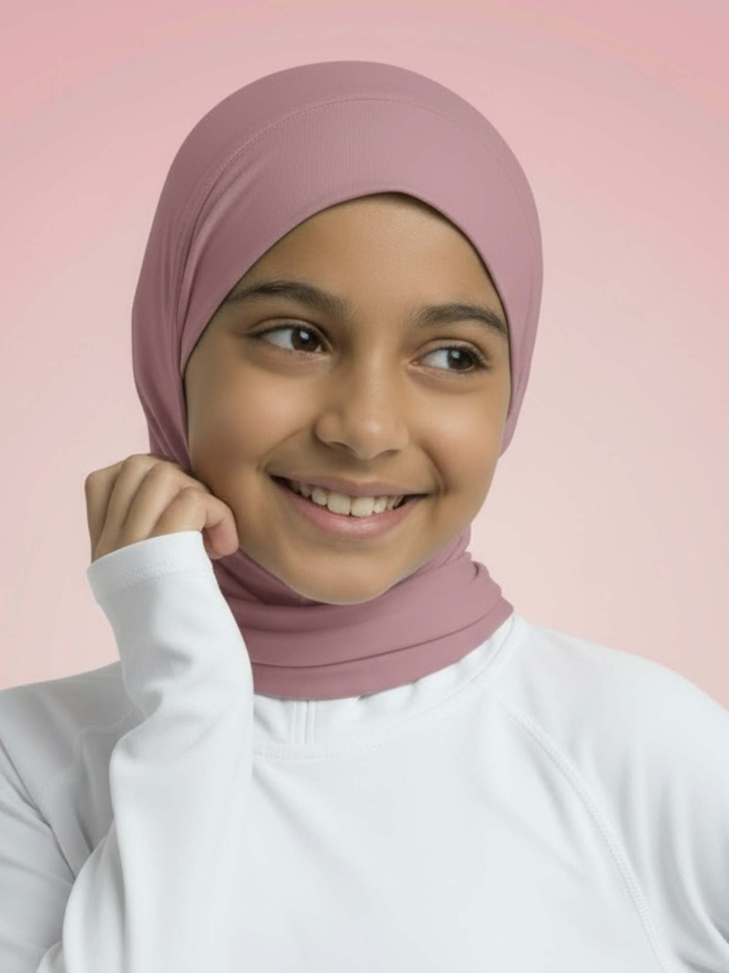 Person wearing a pink hijab and white shirt against a pink background