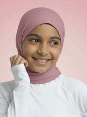 Person wearing a pink hijab and white shirt against a pink background