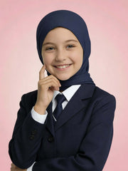 Young girl wearing a navy hijab and dark blazer on a pink background