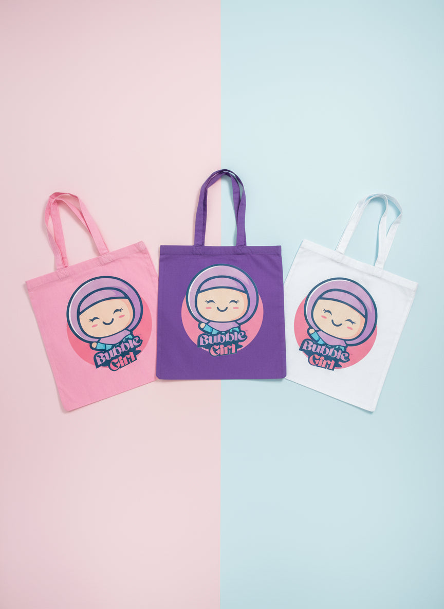 Three tote bags in pink, purple, and white with a cartoon character and 'Bunni Girl' text on a pastel background. Bubble Girl hijab