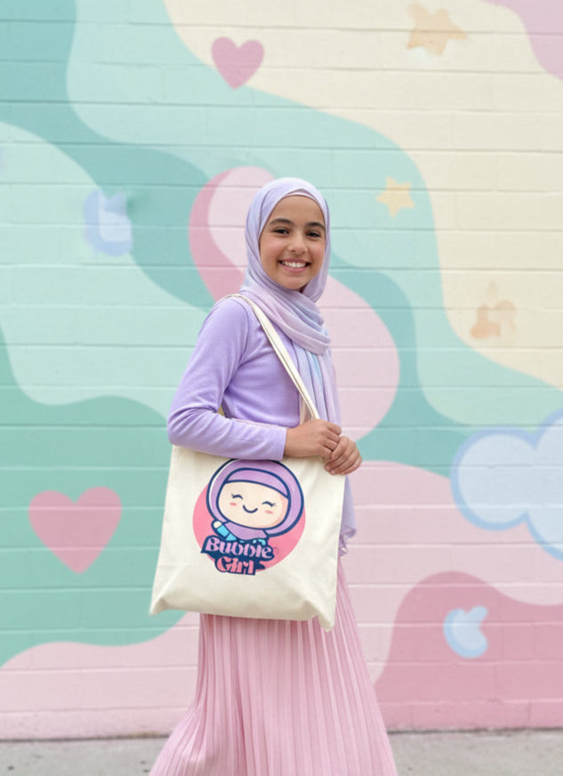 Girl holding a tote bag with a cartoon character against a colorful mural background Bubble Girl hijab