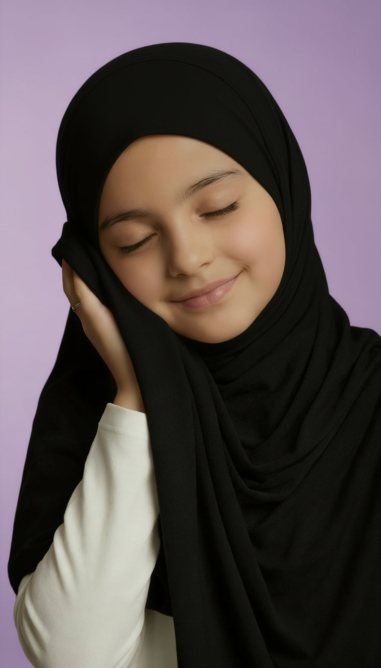 child wearing a black hijab against a purple background