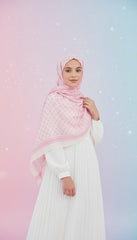 Woman wearing a pink hijab and white outfit against a gradient background