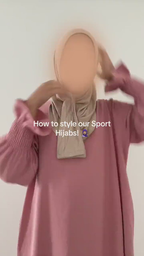 Girl putting on the FitWrap instant sports hijab, pulled on in one motion with no pins