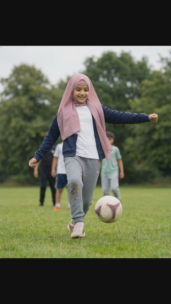 Girls playing football and twirling in FeatherLite instant hijabs, the georgette moving while the undercap stays in place