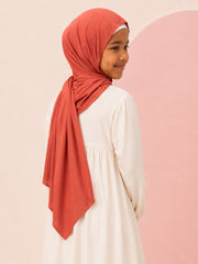 Back view of the rust jersey hijab for girls, showing the draped tail