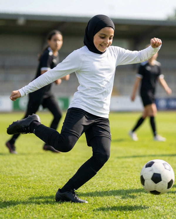 Girl in a black FitWrap sports hijab on an outdoor sports court